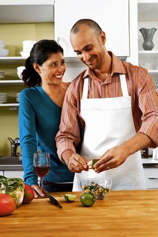 couple cooking guy cutting peppers