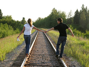 couple on railroad tracks medium new