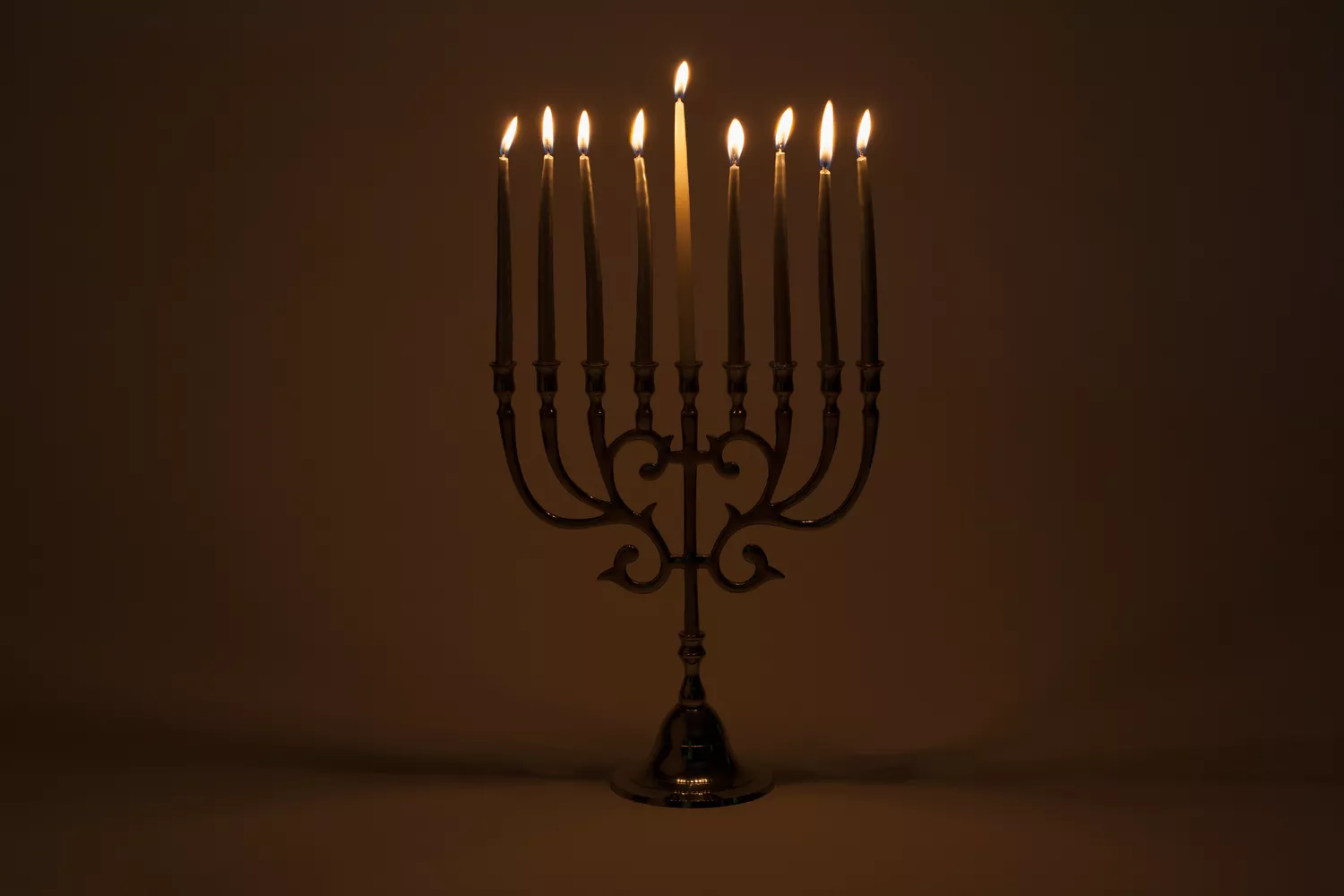 menorah with lit candles 166262951 59ee602e054ad9001083934e